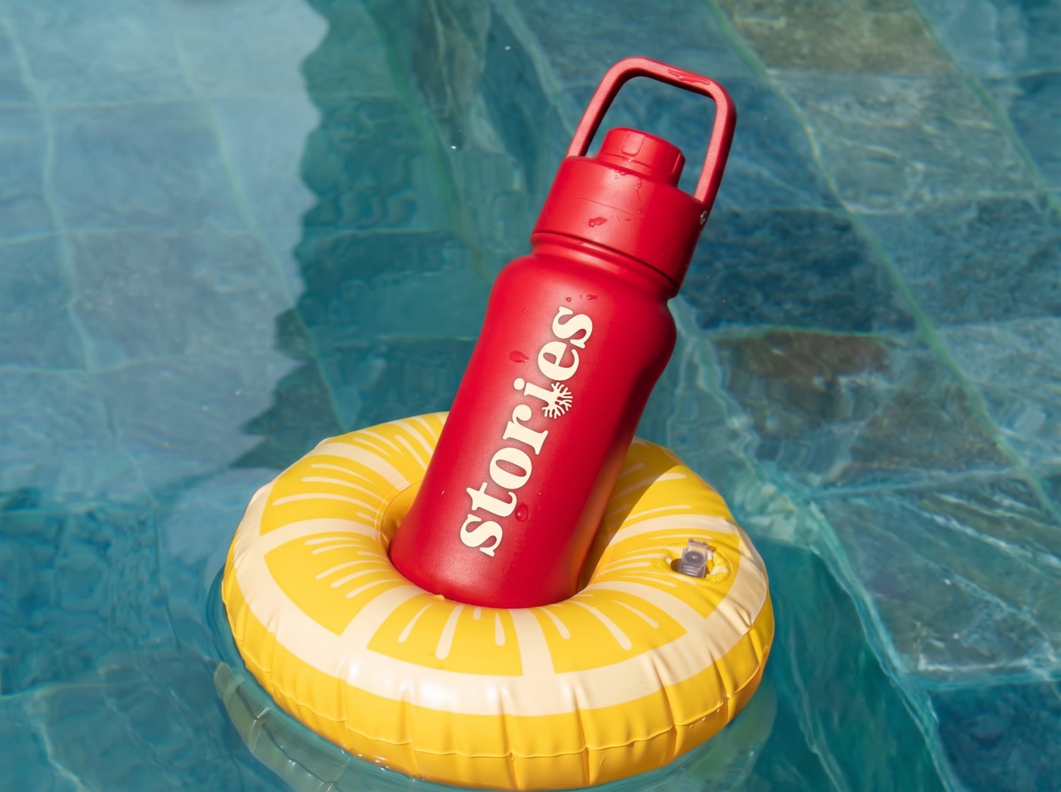 Stories branded bottle by the pool